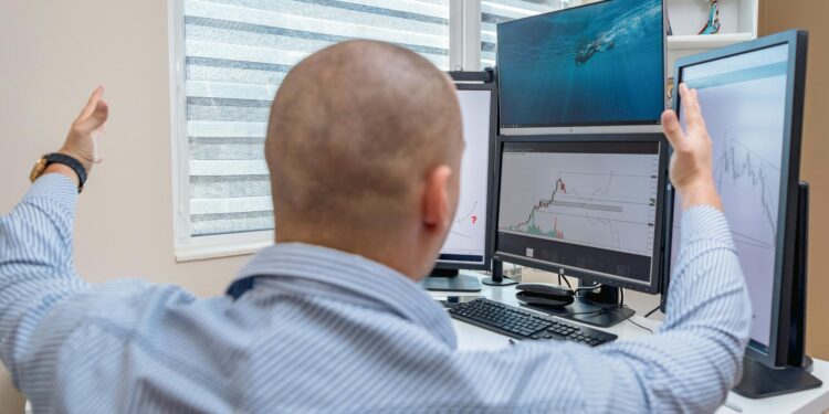 Traders monitoring stock market charts on screens reflect positive financial sentiment.
