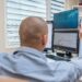 Traders monitoring stock market charts on screens reflect positive financial sentiment.