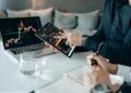 A business meeting with charts and graphs focused on cryptocurrency and finance.
