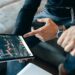 Financial professionals analyzing Bitcoin options trading on digital screens.