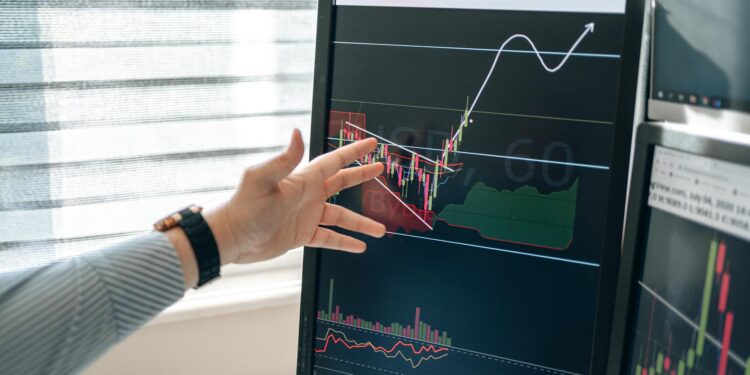 A financial analyst studies Bitcoin ETF charts and graphs on a digital screen.