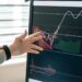 A financial analyst studies Bitcoin ETF charts and graphs on a digital screen.