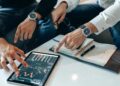 XRP investors reviewing cloud mining strategies with SHR Miner software on a computer screen.
