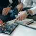 A financial advisor reviewing crypto asset data on a digital tablet.
