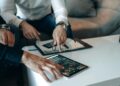 Senators discuss the CLARITY Act, with crypto graphs and stablecoin icons in the background.