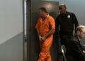 Gannon Ken Van Dyke being escorted by law enforcement after his insider trading arrest.