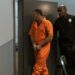 Gannon Ken Van Dyke being escorted by law enforcement after his insider trading arrest.