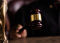 Judge's gavel with cryptocurrency symbols, highlighting regulatory action against prediction markets.