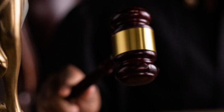 Judge's gavel with cryptocurrency symbols, highlighting regulatory action against prediction markets.