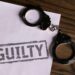 Delio CEO in handcuffs, leaving court after crypto fraud proceedings.