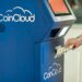 Bitcoin and crypto ATMs displayed in a public location with financial notices nearby.