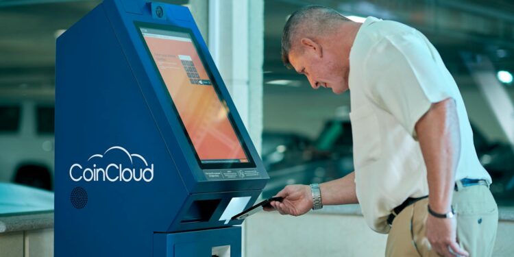 A cryptocurrency ATM in a public space surrounded by warning signs about fraud.