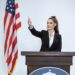 Melania Trump speaking at a podium during a White House event, expressing denial of Epstein ties.