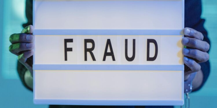 Law enforcement agents examining cryptocurrency hardware linked to a major fraud investigation.