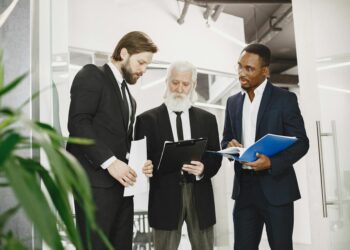 Business executives discussing Bitcoin growth strategy in a modern office setting.