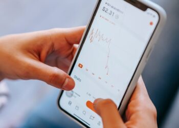 A person using a smartphone to access a cryptocurrency loan app interface.