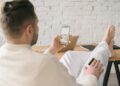 A person using a smartphone to make a food order with crypto payment options visible.