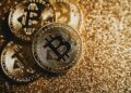 Bitcoin and gold coins intertwined on a digital background symbolizing COINSOV Index launch.