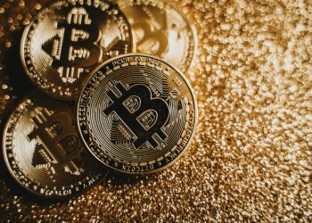 Bitcoin and gold coins intertwined on a digital background symbolizing COINSOV Index launch.