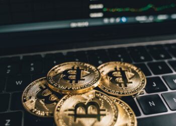 A close-up of a quantum computer with Bitcoin symbols around it, representing cryptographic threats.