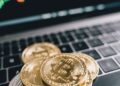 Bitcoin coins stacked with financial graphs and dollar signs, symbolizing crypto market growth.