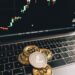 Crypto coins and a computer screen displaying financial data related to the Drift hack.