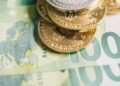 Euro banknotes and cryptocurrency coins on a financial report background, symbolizing regulation.