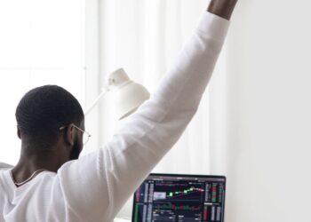 A miner celebrates with a laptop and Bitcoin graphics after winning a significant block reward.