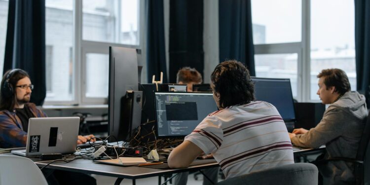 Team of engineers working on AI technology in a modern office setting with Pentagon models.