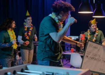A diverse team celebrates with a trophy and a check after winning a hackathon for blockchain innovation.