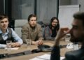 Amazon and Anthropic teams discussing AI advancements in a modern conference room.
