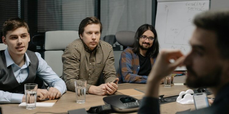 Executives from major tech firms discuss AI standards at a conference table.