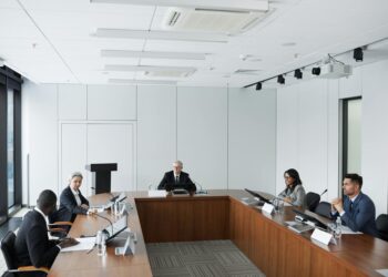 KBank executives discussing blockchain remittances with Ripple representatives in a conference room.