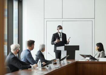 A diverse group of regulators discussing cryptocurrency regulations at a conference table.