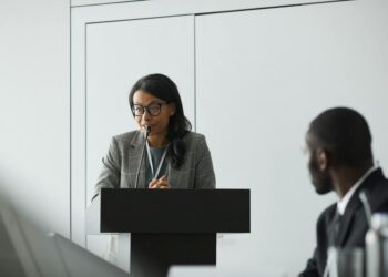 Vugar Usi speaking at a podium during MEXC's CEO announcement event.