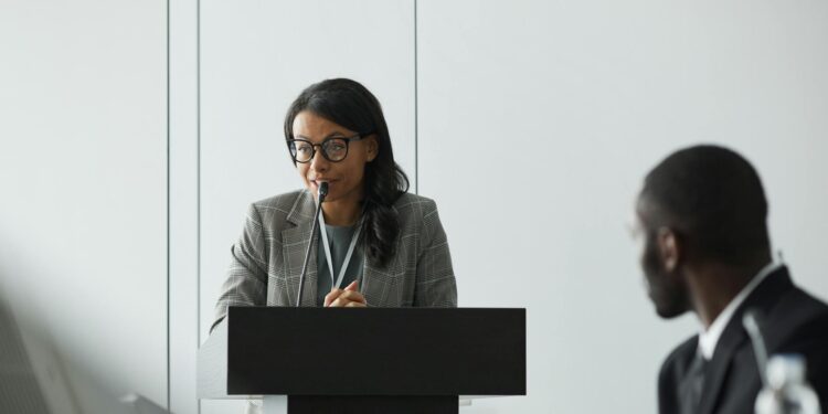 Vugar Usi speaking at a podium during MEXC's CEO announcement event.