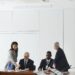 Employees at a desk meeting discussing the new PAC and implications for government regulations.