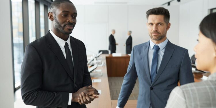 OpenAI executives discussing strategies with TBPN representatives in a modern office setting.