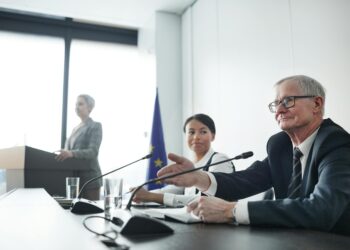 Legislators discussing cryptocurrency regulations in a formal setting.