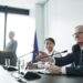 Legislators discussing cryptocurrency regulations in a formal setting.