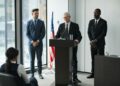 David Woodcock at a podium addressing SEC enforcement strategies in finance regulation.