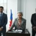Three politicians at a press conference, discussing regulations and insider trading issues.