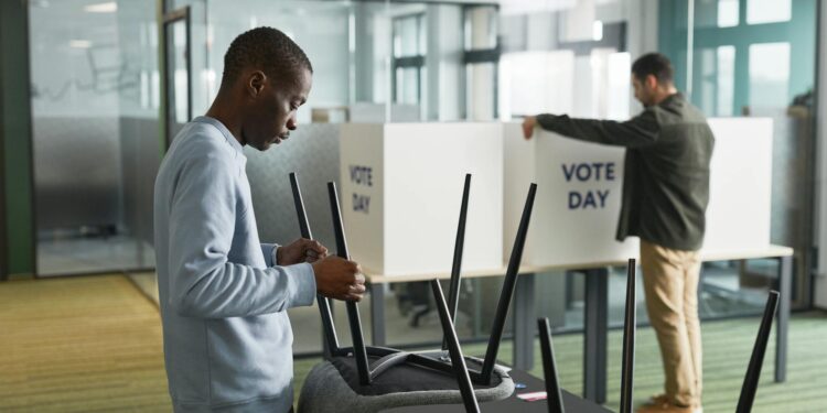 Voters at a polling station review ballots for Virginia's redistricting plan.