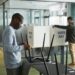 Voters at a polling station review ballots for Virginia's redistricting plan.