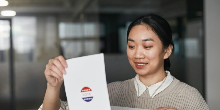 A woman in business attire exits a government building, carrying documents related to voter data.
