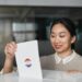 A woman in business attire exits a government building, carrying documents related to voter data.