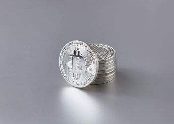 A close-up of Bitcoin coins stacked, symbolizing the financial error at Bithumb.