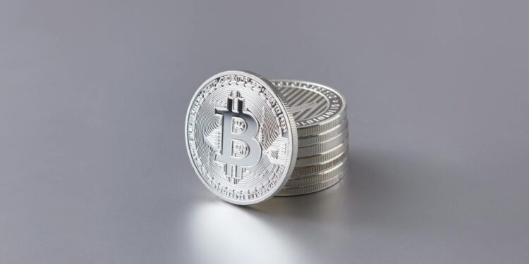 A close-up of Bitcoin coins stacked, symbolizing the financial error at Bithumb.