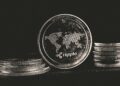 Ripple Labs logo with XRP and RLUSD tokens, representing crypto integration in finance.