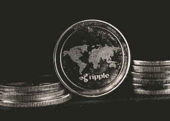 Ripple Labs logo with XRP and RLUSD tokens, representing crypto integration in finance.
